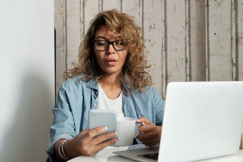 accountant working from home with phone and laptop